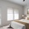 a bedroom with a bed and a fan