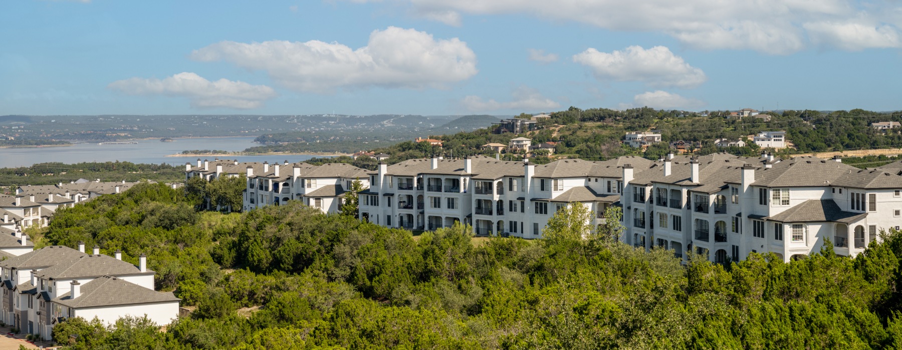 building surrounded by trees near a body of water