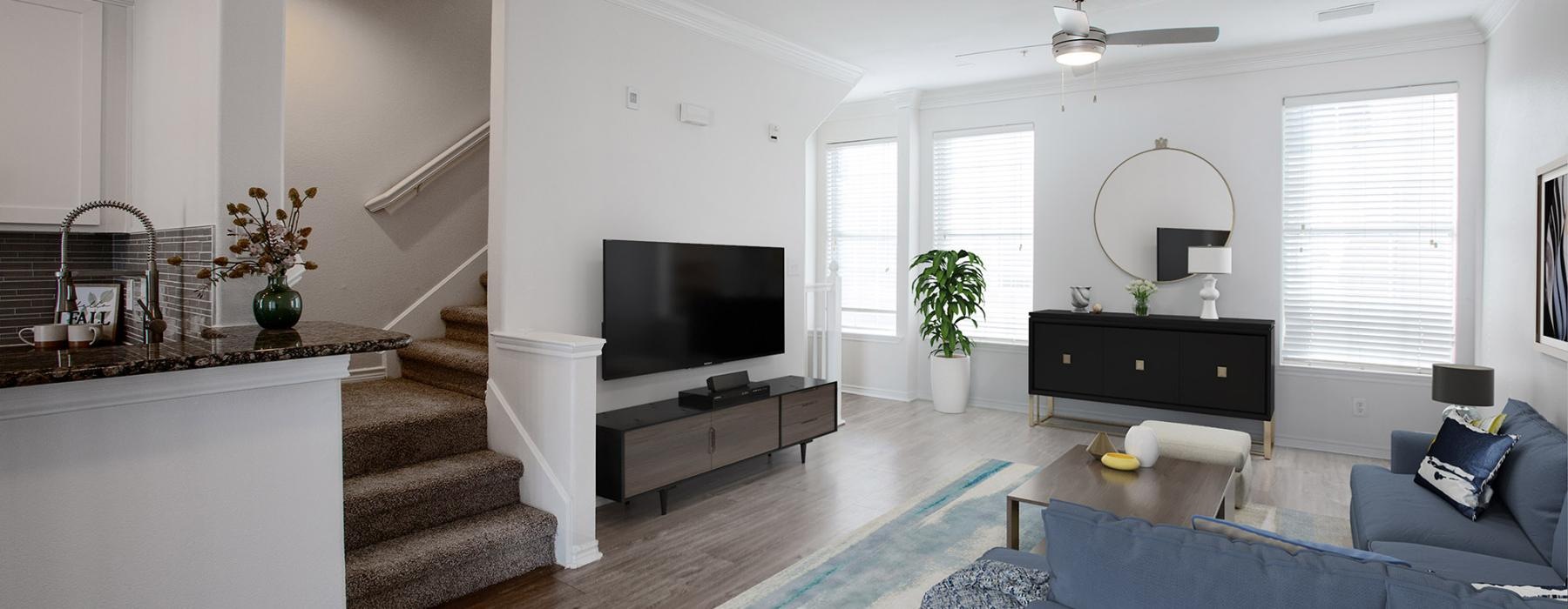 a living room with a tv and couches